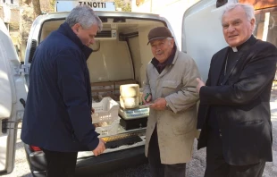 Archbishop Francesco Giovanni Brugnaro of Camerino-San Severino Marche and Papal Almoner Archbishop Konrad Krajewski purchase food from small farmers. Photo courtesy of the Holy See Press Office.