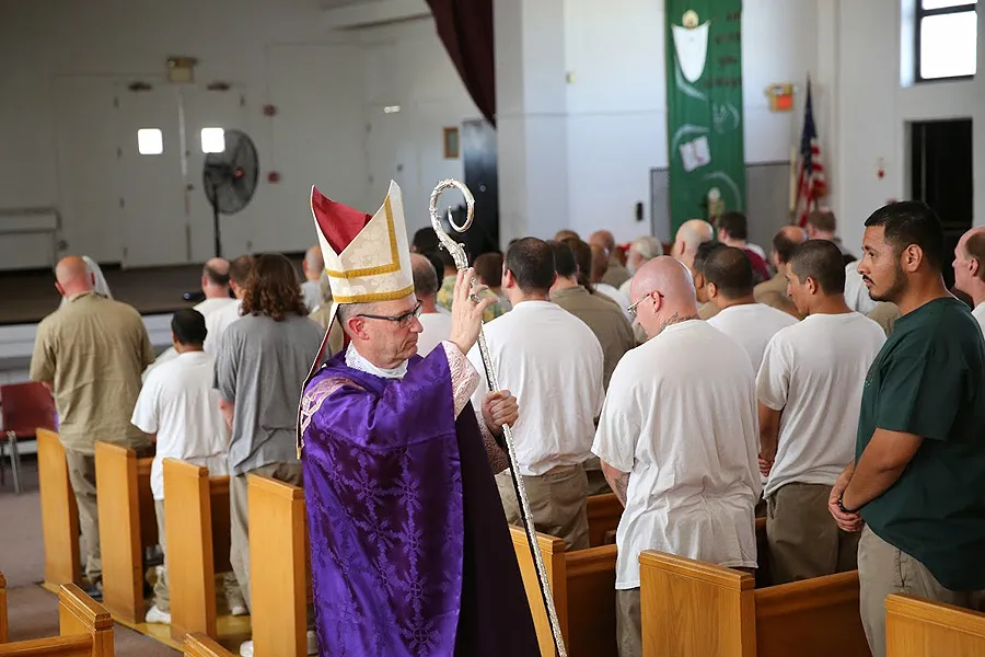 Bishop James Conley of Lincoln blesses prisoners at the Nebraska State Penitentiary during the recessional of a Mass said March 31, 2015. Photo courtesy of the Southern Nebraska Register.?w=200&h=150