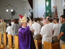Bishop James Conley of Lincoln blesses prisoners at the Nebraska State Penitentiary during the recessional of a Mass said March 31, 2015. Photo courtesy of the Southern Nebraska Register.