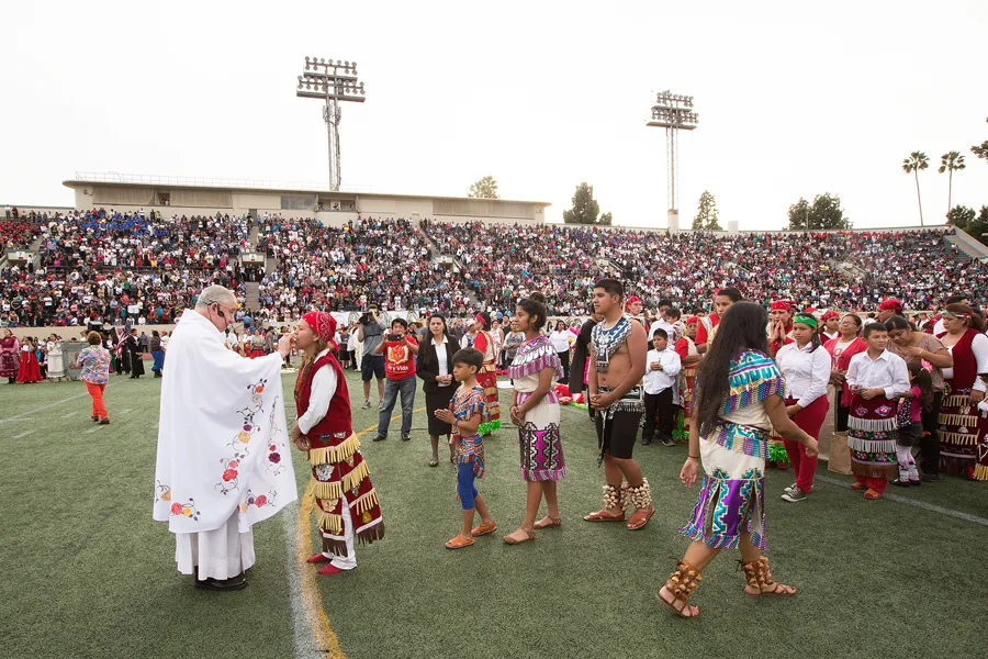 Archbishop José Gomez distributes Communion during Mass in Weingart Stadium at East Los Angeles College. ?w=200&h=150