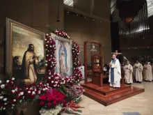Archbishop Jose Gomez of Los Angeles venerates an image of Our Lady of Guadalupe while saying Mass at the Cathedral of Our Lady of the Angels, Dec. 12, 2017. 