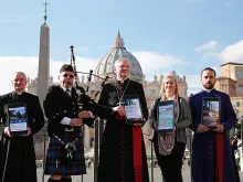 Archbishop Leo Cushley (C) demonstrates The Catholic App in St. Peter's Square, Nov. 22, 2016. 