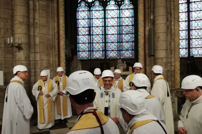 Archbishop Michel Aupetit C greets other clerics following the first Mass held in the side chapel June 15 2019 in Paris Credit Karine Perret AFP Getty Images