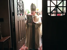 Archbishop Patricio Flores passes through the holy doors at the Basilica of the National Shrine of the Little Flower, Jan. 1, 2000 in Texas. 