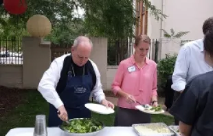 Archbishop Samuel Aquila (left) serves food during the Christ in the City fundraiser in Denver, Sept 4, 2013 (File Photo/CNA). 