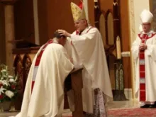 Archbishop Thomas Wenski lays hands on Bishop Gregory Parkes, during the rite of ordination of a bishop. Courtesy photo: Sister Elizabeth Worley.