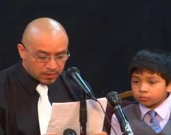 Arturo Martinez-Sanchez reads a statement at the press conference with one of his sons. Photo used with permission.?w=200&h=150