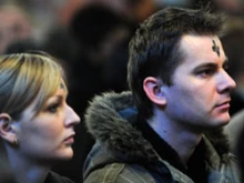 Two young people participating in an Ash Wednesday Service in Westminster Cathedral. 