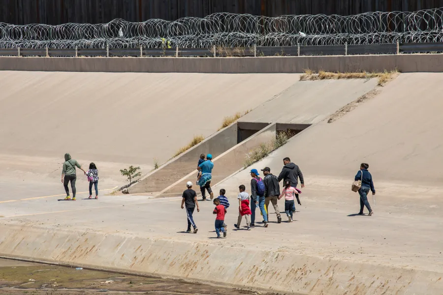 Migrants from Central America cross the US-Mexico border to seek asylum in the United States.   Credit: Mike Hardiman/Shutterstock?w=200&h=150