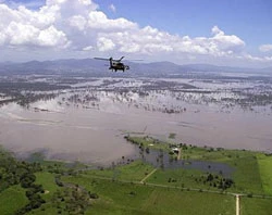 An Australian Army helicopter flies over flooded Queensland. Courtesy of the Commonwealth of Australia?w=200&h=150
