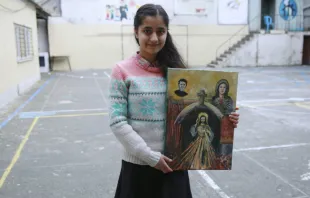 Syrian refugee Sarah, 14, displays a painting she made for Pope Francis.   Daniel Ibanez/CNA.