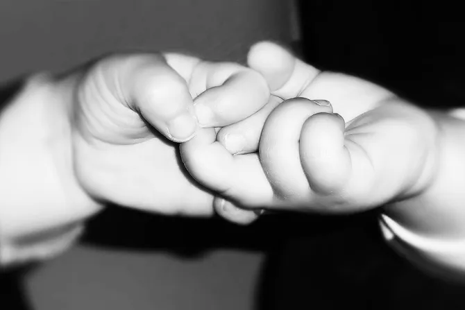 Babies holding hands Credit nicoleverschoor via Flickr CC BY NC ND 20 filter added CNA