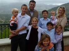 Dressed in a orange and white striped shirt, Joseph Whalin appears with his family. Photo courtesy of the Whalin Family