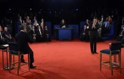 Mitt Romney (R) speaks as President Barack Obama (L) listens during a town hall style debate at Hofstra University October 16, 2012. ?w=200&h=150