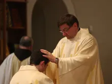 Monsignor James P. Powers, who was appointed Bishop of Superior Dec. 15, blesses a newly ordained priest in June 2014. 