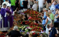 Bishop Gennaro Pascarella blesses the coffins of the 38 bus crash victims on July 30, 2013. ANSA/Ettore Ferrari.?w=200&h=150