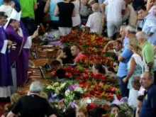 Bishop Gennaro Pascarella blesses the coffins of the 38 bus crash victims on July 30, 2013. ANSA/Ettore Ferrari.