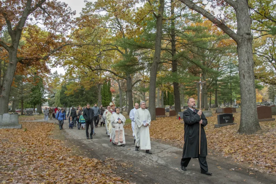 Bishop Robert Gruss of Saginaw processes from a Mass to the burial of the unclaimed remains of 175 people, at Calvary Cemetery in Kawkawlin, Mich., Nov. 2, 2019. ?w=200&h=150