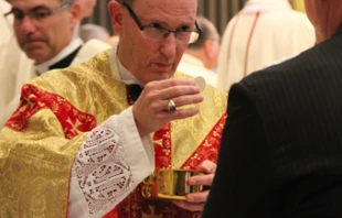 Bishop James D. Conley gives communion during his installation Mass at Risen Christ Cathedral in Lincoln, Neb. on Nov. 20, 2012.