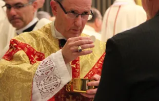Bishop James D. Conley gives communion during his installation Mass at Risen Christ Cathedral in Lincoln, Neb. on Nov. 20, 2012.  