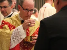 Bishop James Conley of Lincoln distributes Communion during his Mass of Installation, Nov. 20, 2012. 