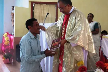 Bishop Pallipparambil presents the New Testament in Wancho to a parishioner at the Chrism Mass March 27 2015 Credit Catholic Diocese of Miao India CNA 4 1 15