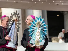 Bishop Paul Mason of the UK Armed Forces (L) and Bishop Santiago Olivera of the Argentine Armed Forces hold statues of Our Lady of Lujan in St. Peter's Square, Oct 30, 2019. 