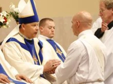 Bishop Richard F. Stika receives promises of respect and obedience from soon-to-be-ordained Douglas Owens during a May 28 Mass at Sacred Heart Cathedral. Photo 