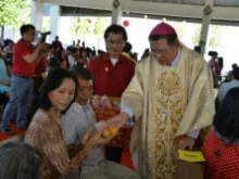 Bishop Silvio Siripong Charatsri distributes gifts for Lunar New Year. 