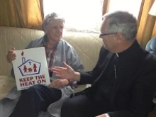 Bishop Thomas J. Tobin of Providence visits with Leo Tremblay in his mobile home in Pawtucket, RI as part of the Keep the Heat on Program. 