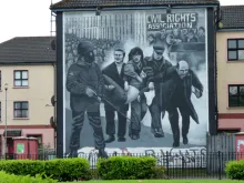 A mural in Derry depicting then-Father Daly leading a group carrying a victim on Bloody Sunday, Jan. 30, 1972.