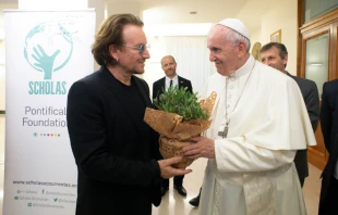Bono gives Pope Francis a plant at the Vatican's Casa Santa Marta, Sept. 19, 2018.   Vatican Media.