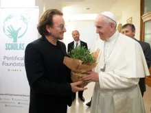 Bono gives Pope Francis a plant at the Vatican's Casa Santa Marta, Sept. 19, 2018. 