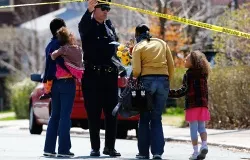 A family leaves flowers in front of the home of the Richard family whose eight-year-old son, Martin, was killed during the Boston explosions. ?w=200&h=150