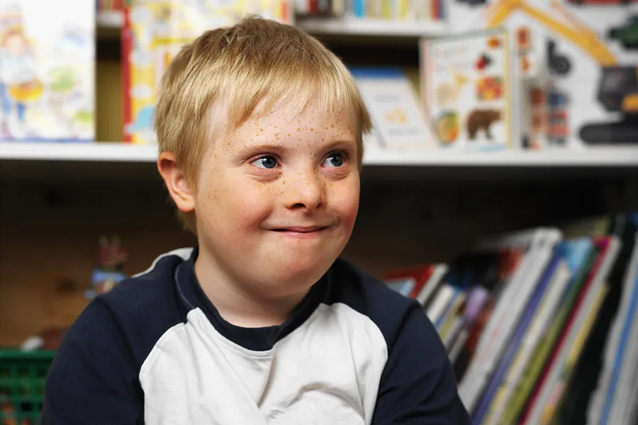 Boy with Down syndrome in a classroom. ?w=200&h=150