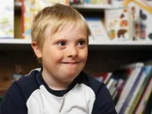 Boy with Down syndrome in a classroom. 