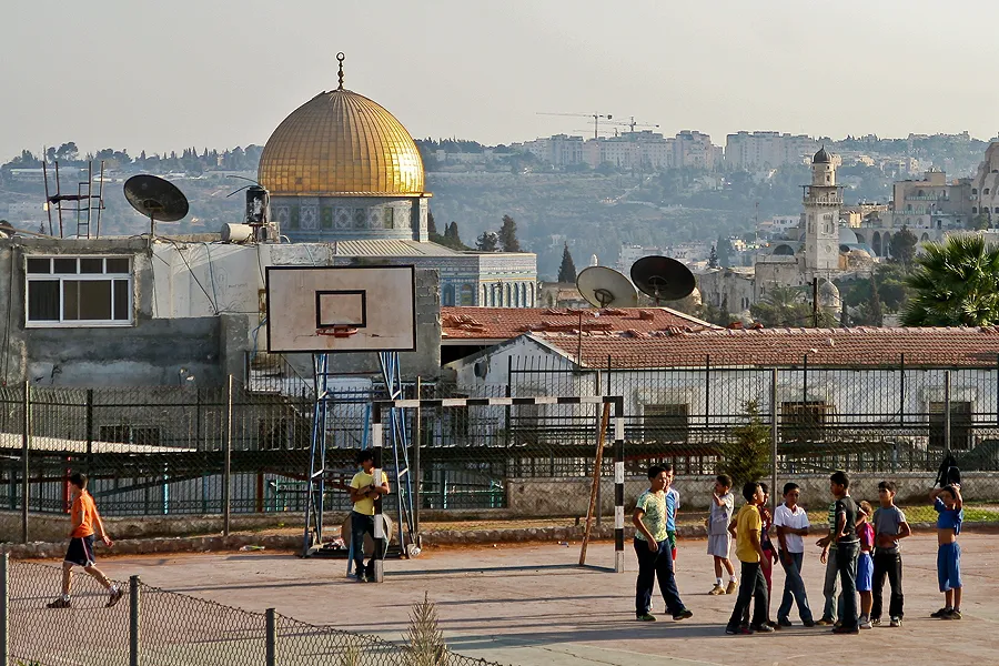 Boys play soccer on a basketball court in Jerusalem. ?w=200&h=150