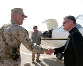 Brig. Gen. John Wissler, the deputy commanding general of Multi National Force - West, welcomes to Al Asad Air Base AMS Archbishop Timothy P. Broglio.  Photo ?w=200&h=150