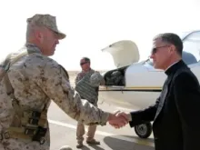 Brig. Gen. John Wissler, the deputy commanding general of Multi National Force - West, welcomes to Al Asad Air Base AMS Archbishop Timothy P. Broglio.  Photo 