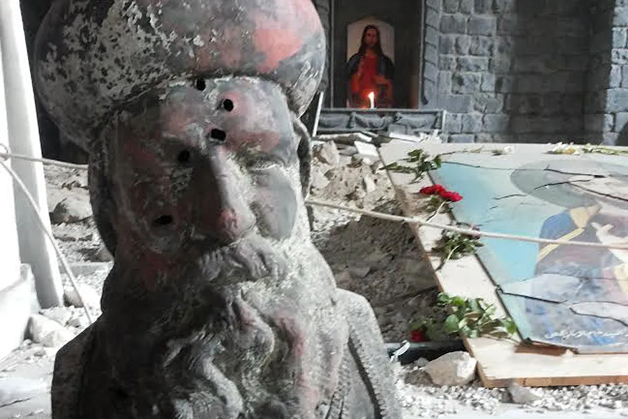 A bullet-riddent bust of St. Ephrem in the remains of St. Mary's Syrian Orthodox parish in Homs. Photo courtesy of Aid to the Church in Need.?w=200&h=150