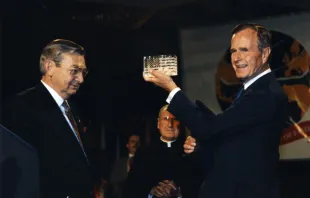 Former Supreme Knight Virgil Dechant presents President Bush with a Steuben glass replica of the American flag at the Knights’ 1992 convention.   Knights of Columbus