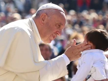 Pope Francis greets a child at a general audience at the Vatican, April 20, 2016.