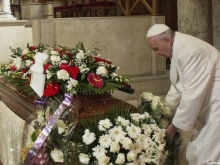 Pope Francis lays a bouquet on Vatican employee Miriam Wuolou's coffin Feb. 20, 2016. 