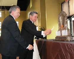 Archbishop Gustavo and Rabbi Bitranstep forward to light the Hanukkiah during a special joint celebration of Catholics and Jews. ?w=200&h=150