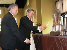 Archbishop Gustavo and Rabbi Bitranstep forward to light the Hanukkiah during a special joint celebration of Catholics and Jews. 