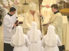 Cardinal Dolan distributes the Constitutions of the Congregation to the newly professed. 