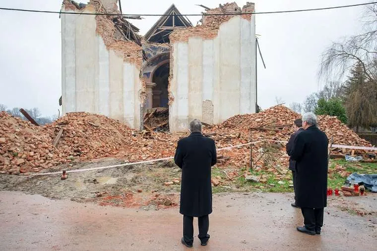 Cardinal Josip Bozanić of Zagreb prays in front of a destroyed church in Žažina, Croatia on Jan. 4, 2021. Courtesy of the Archdiocese of Zagreb.?w=200&h=150