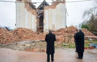 Cardinal Josip Bozanić of Zagreb prays in front of a destroyed church in Žažina, Croatia on Jan. 4, 2021. Courtesy of the Archdiocese of Zagreb.