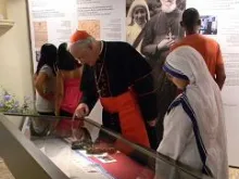 Cardinal Marc Ouellet examines Mother Teresa's sandals along with a Missionaries of Charity sister on Thursday afternoon