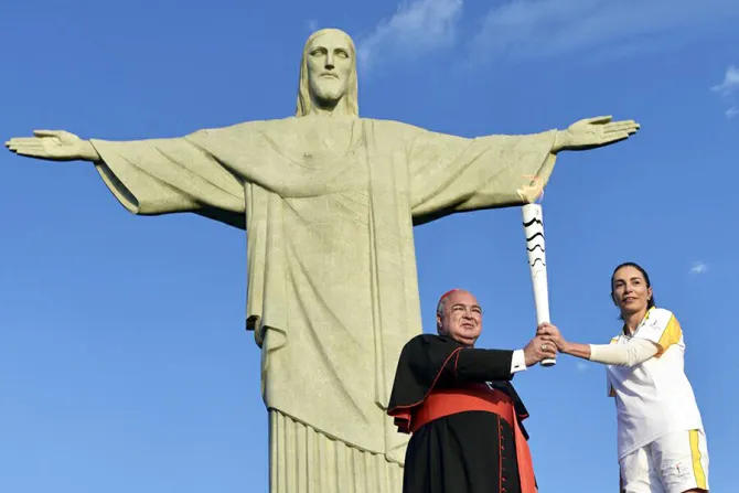 Cardinal Orani Joao Tempesta holds the Olympic torch with former Olympian Isabel Salgado in Rio Aug 4 2016 Credit Gustavo de Oliveira ArqRio CNA